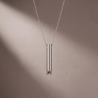 Close-up of the Fermata Chime pendant's brushed-steel finish